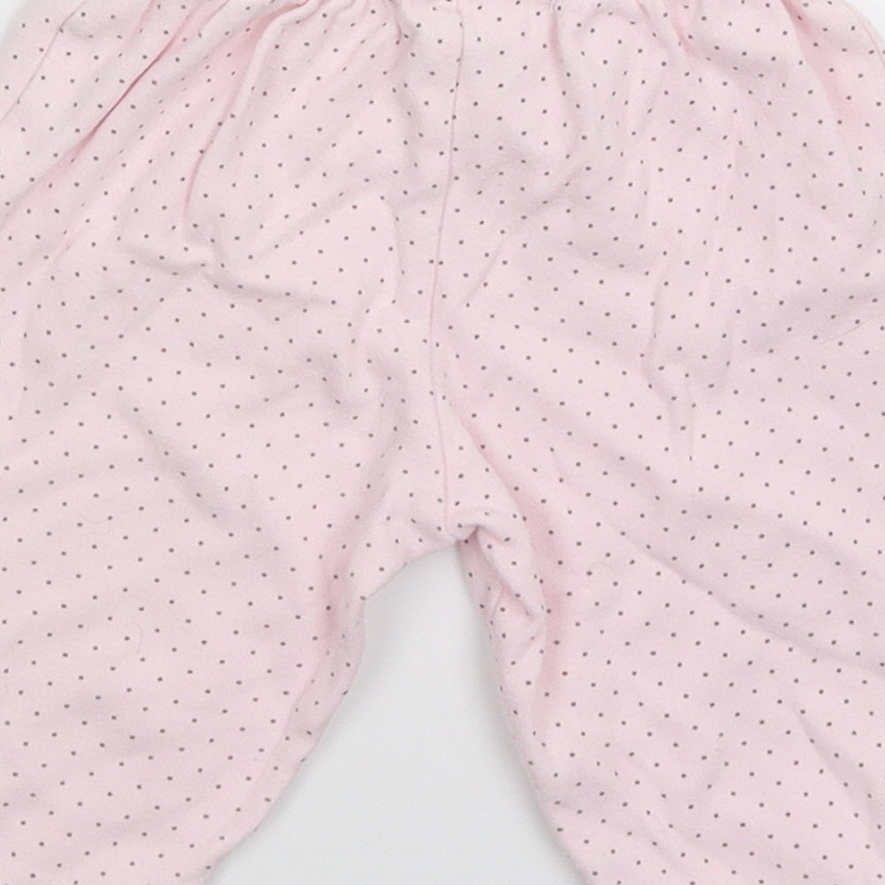 Brand and care label for Puddles n Bubbles girls’ pink spotted sweatpants, size 6-9, months