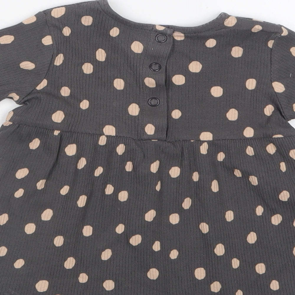 Brand and care label for George girls’ grey polka dot t-shirt dress, size 0-3, months