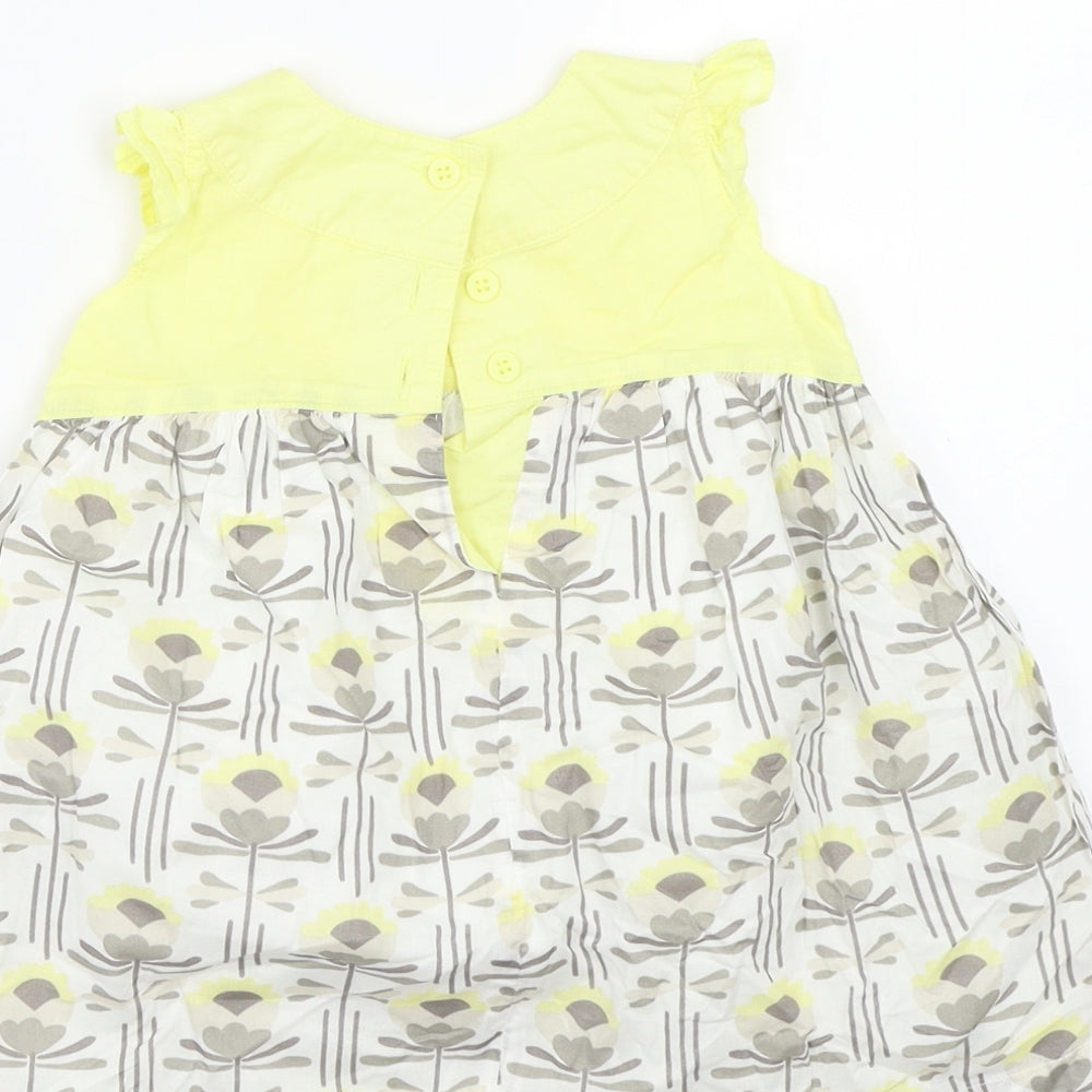 Brand and care label for Next girls’ yellow a-line, size 9-12, months