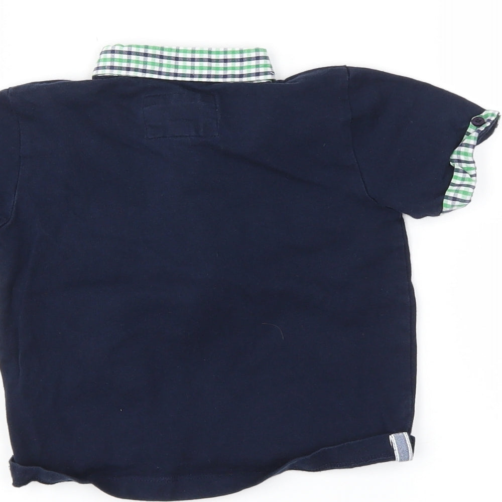 Brand and care label for junior boys’ black basic polo, size 12-18, months