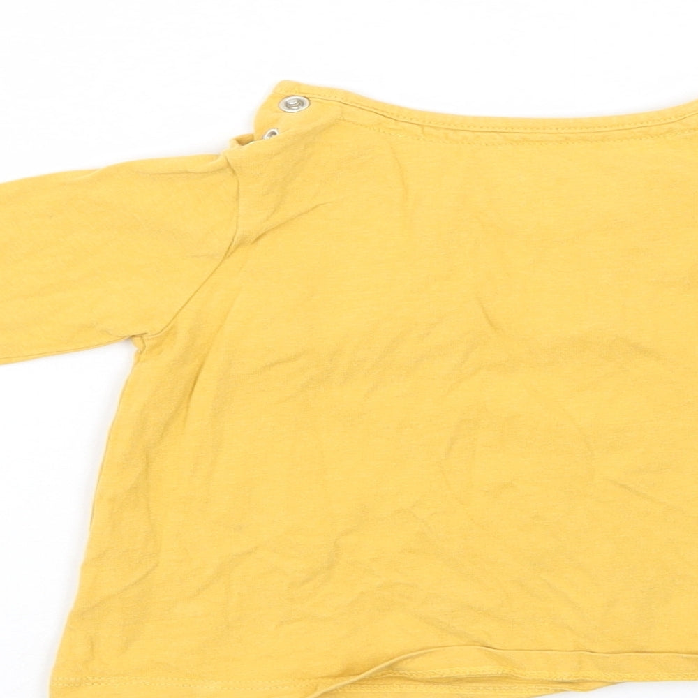 Brand and care label for Tu girls’ yellow pullover casual, size 9-12, months