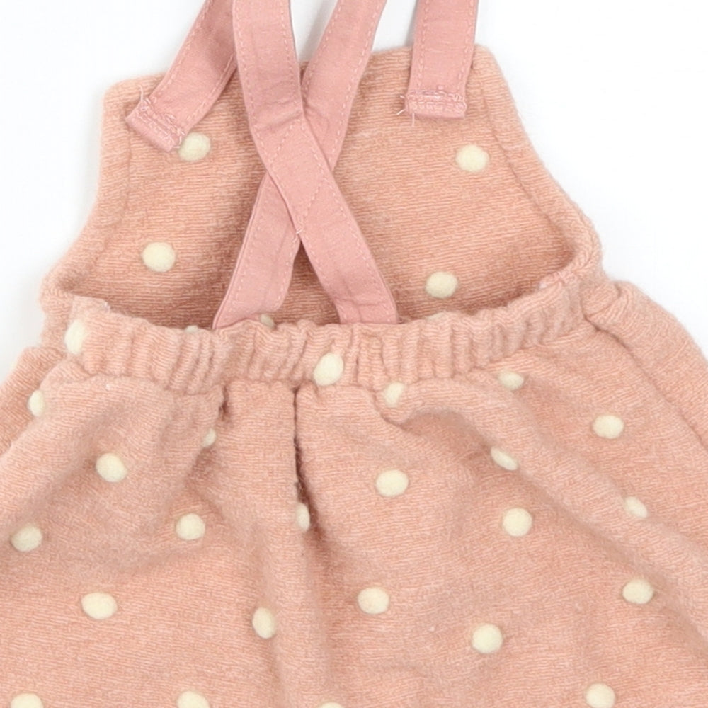 Brand and care label for George girls’ pink polka dot skater dress, size 0-3, months
