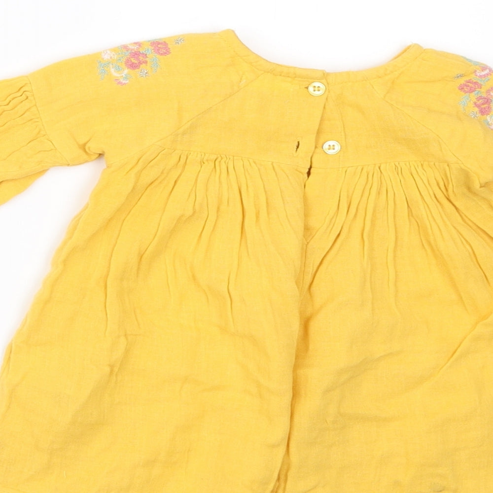 Brand and care label for Next girls’ yellow a-line, size 3-6, months