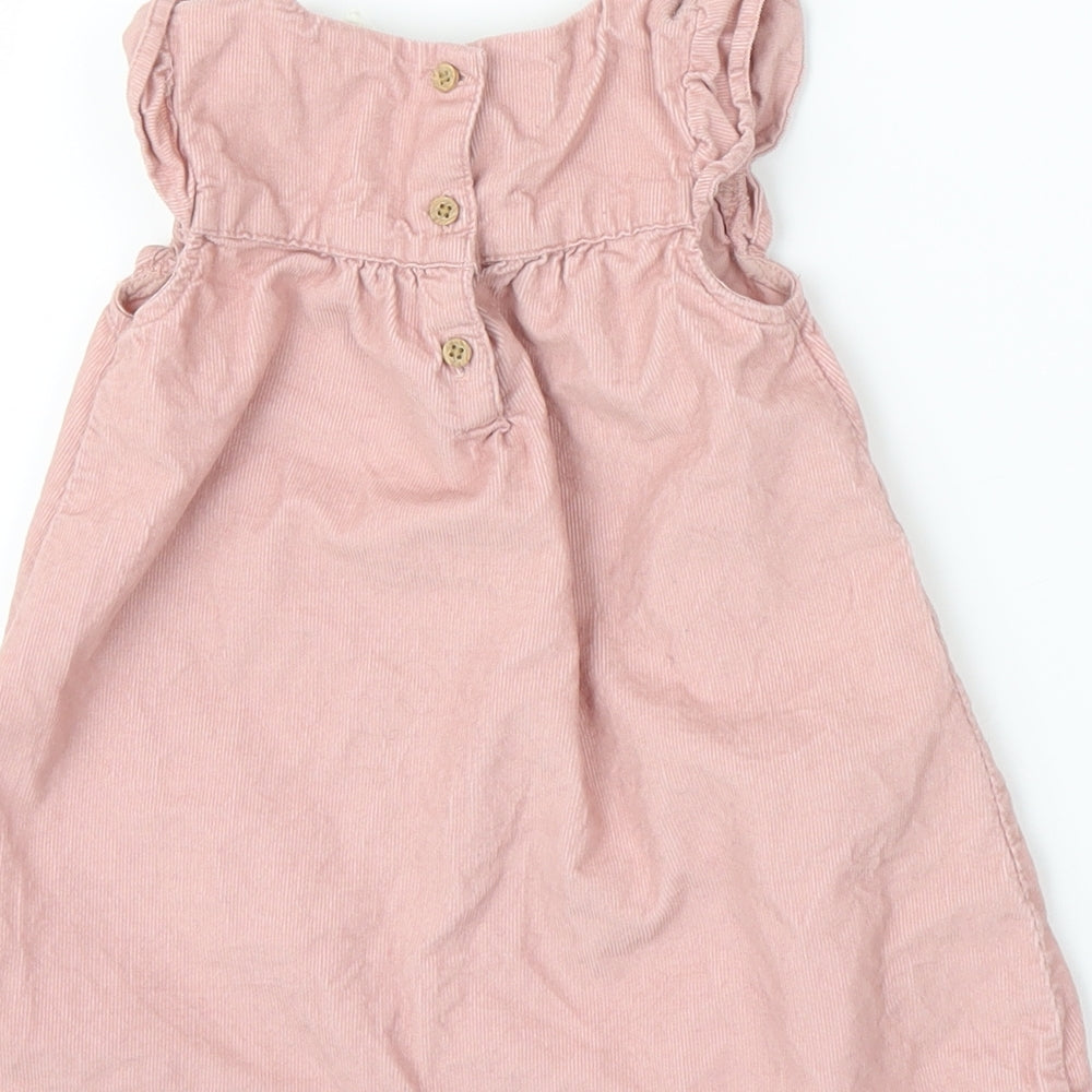 Brand and care label for H&M girls’ pink corduroy a-line, size 6-9, months