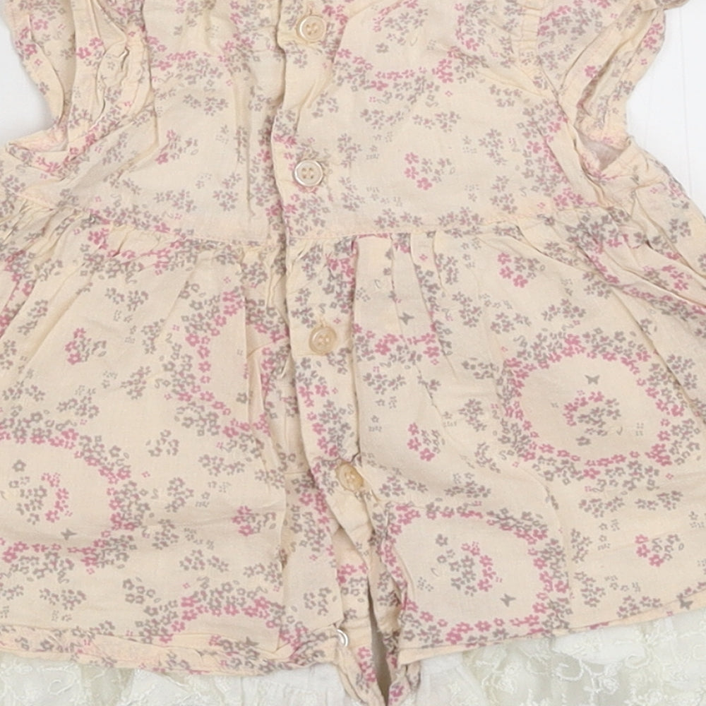 Brand and care label for Rockabye-Baby girls’ beige floral shirt dress, size 3-6, months