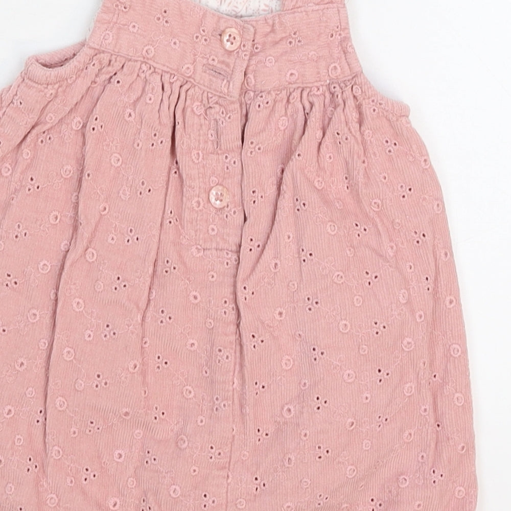 Brand and care label for Monsoon girls’ pink pinafore/dungaree dress, size 0-3, months