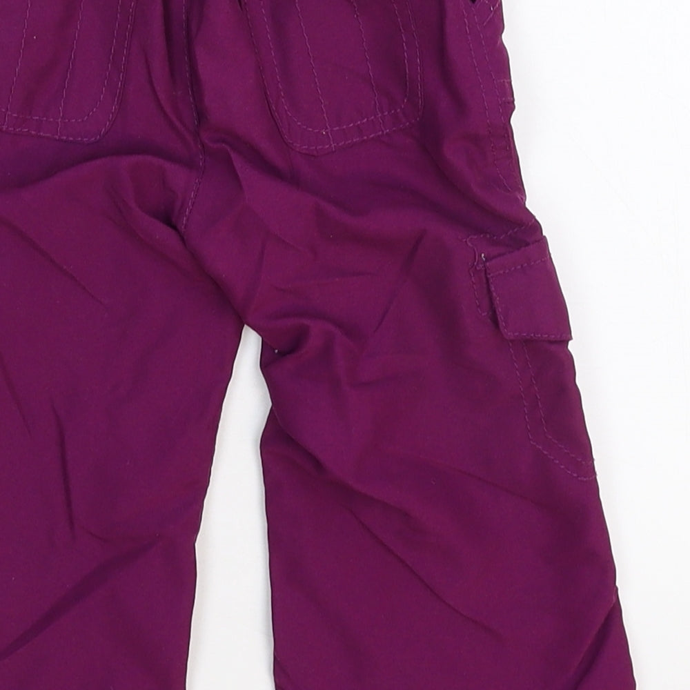 Brand and care label for Early Days girls’ purple cargo trousers, size 6-9, months
