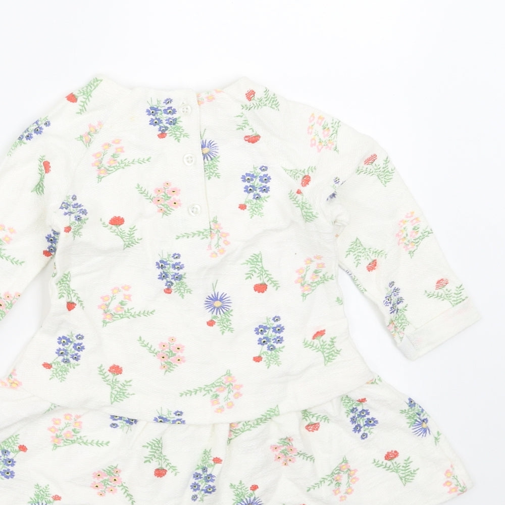 Brand and care label for Dunnes Stores girls’ white floral fit & flare, size 6-9, months