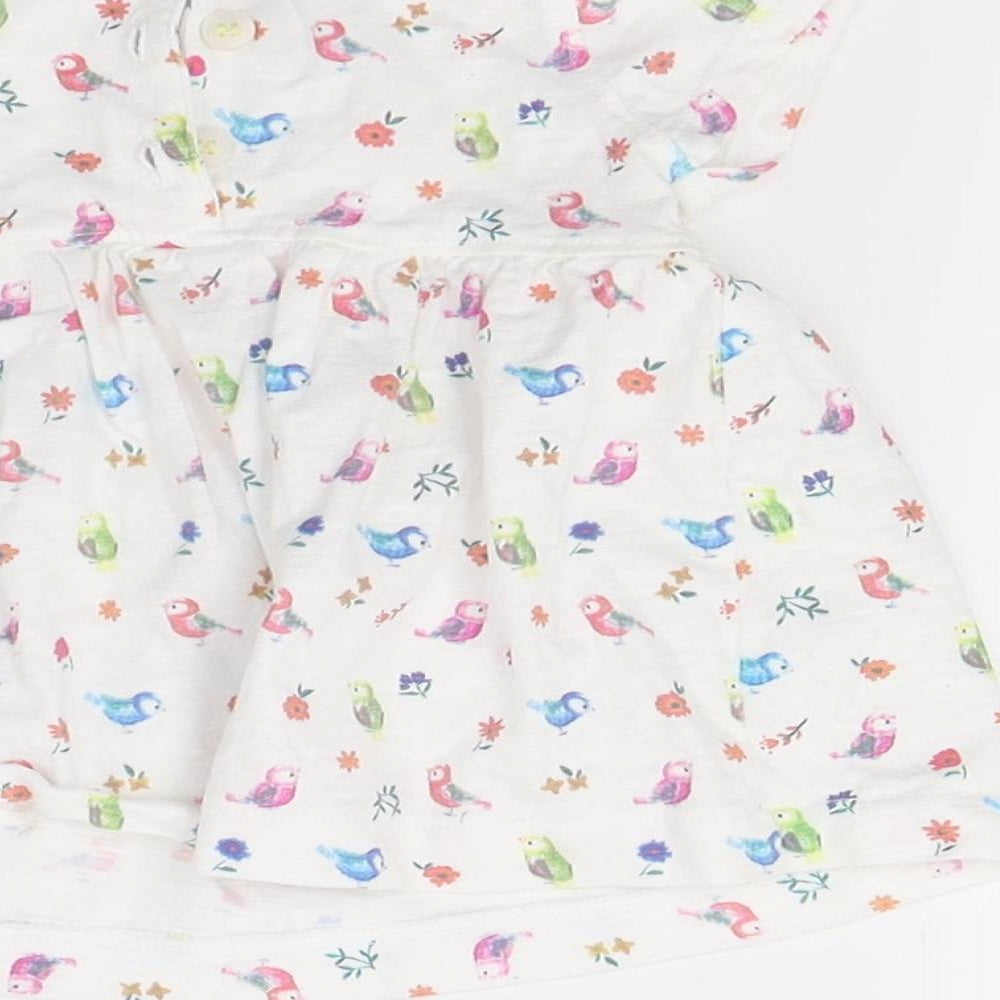 Brand and care label for Mini Club girls’ white floral t-shirt dress, size 0-3, months
