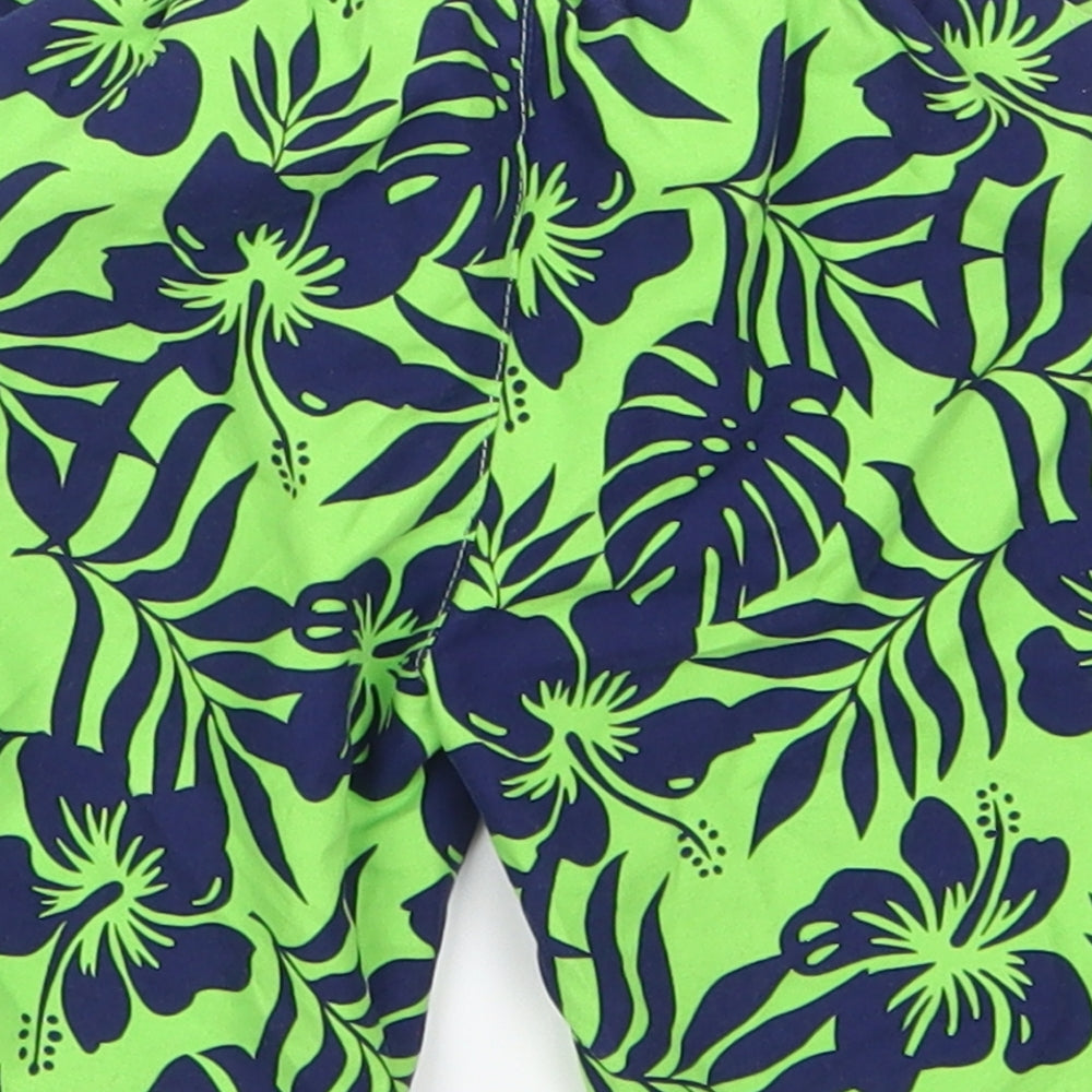 Brand and care label for Mothercare boys’ green floral cropped trousers, size 18-24, months