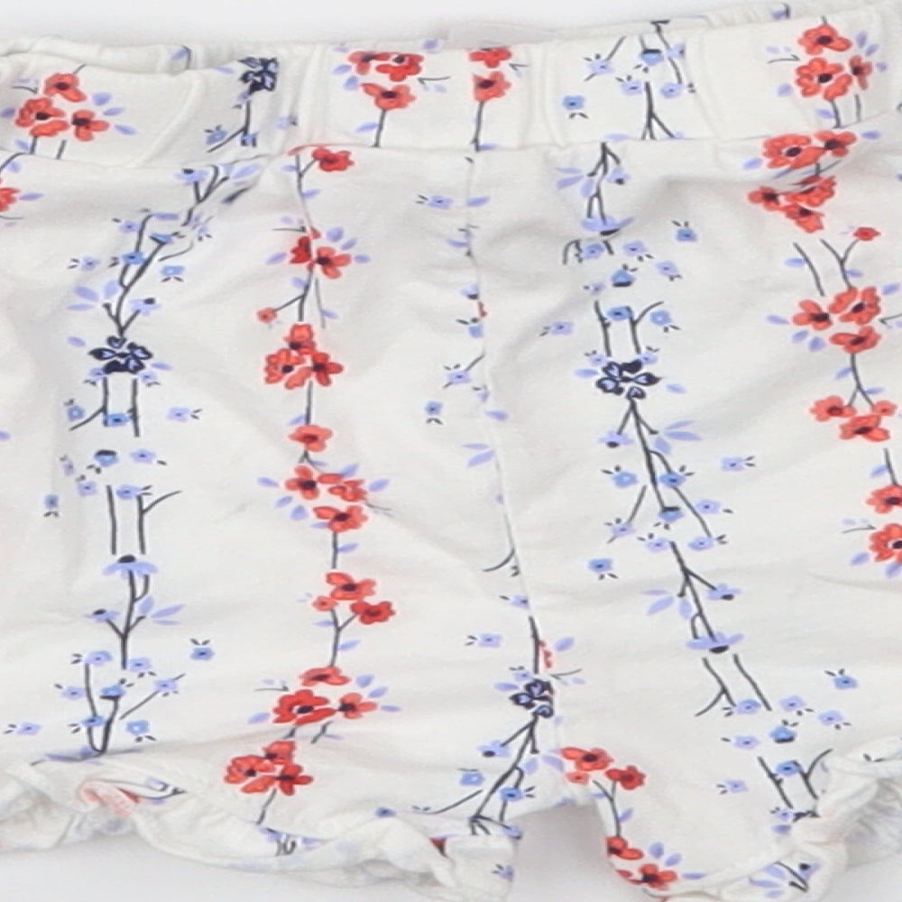 Brand and care label for Matalan girls’ white floral cropped trousers, size 9-12, months