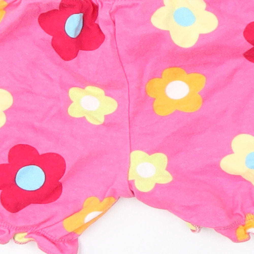 Brand and care label for Preworn girls’ pink floral cropped trousers, size 3-6, months
