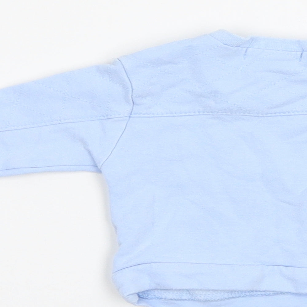 Brand and care label for KrisXKids Baby Blue jumper, size 0-3, Months