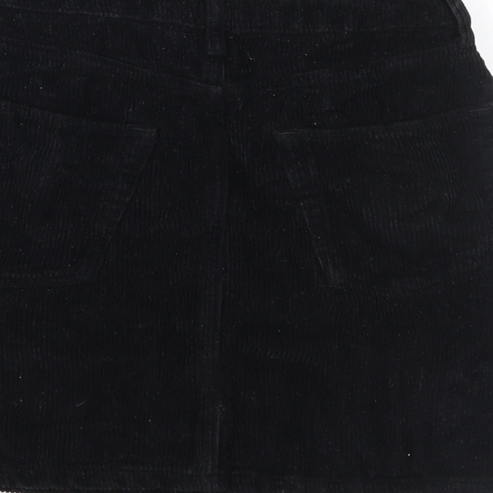 Brand and care label for BDG women’s black corduroy mini skirt, size S