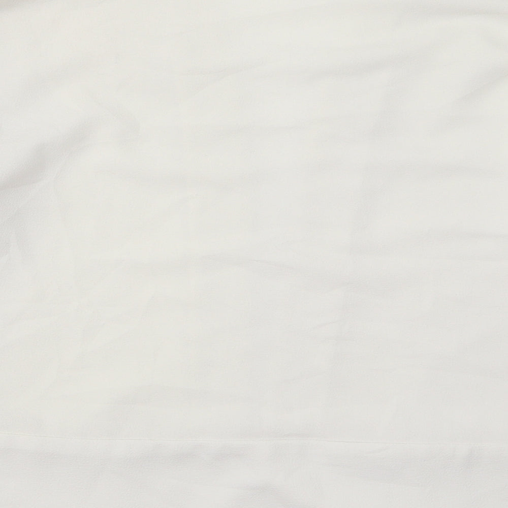 Brand and care label for Miss Selfridge women’s white jacket, size UK 10