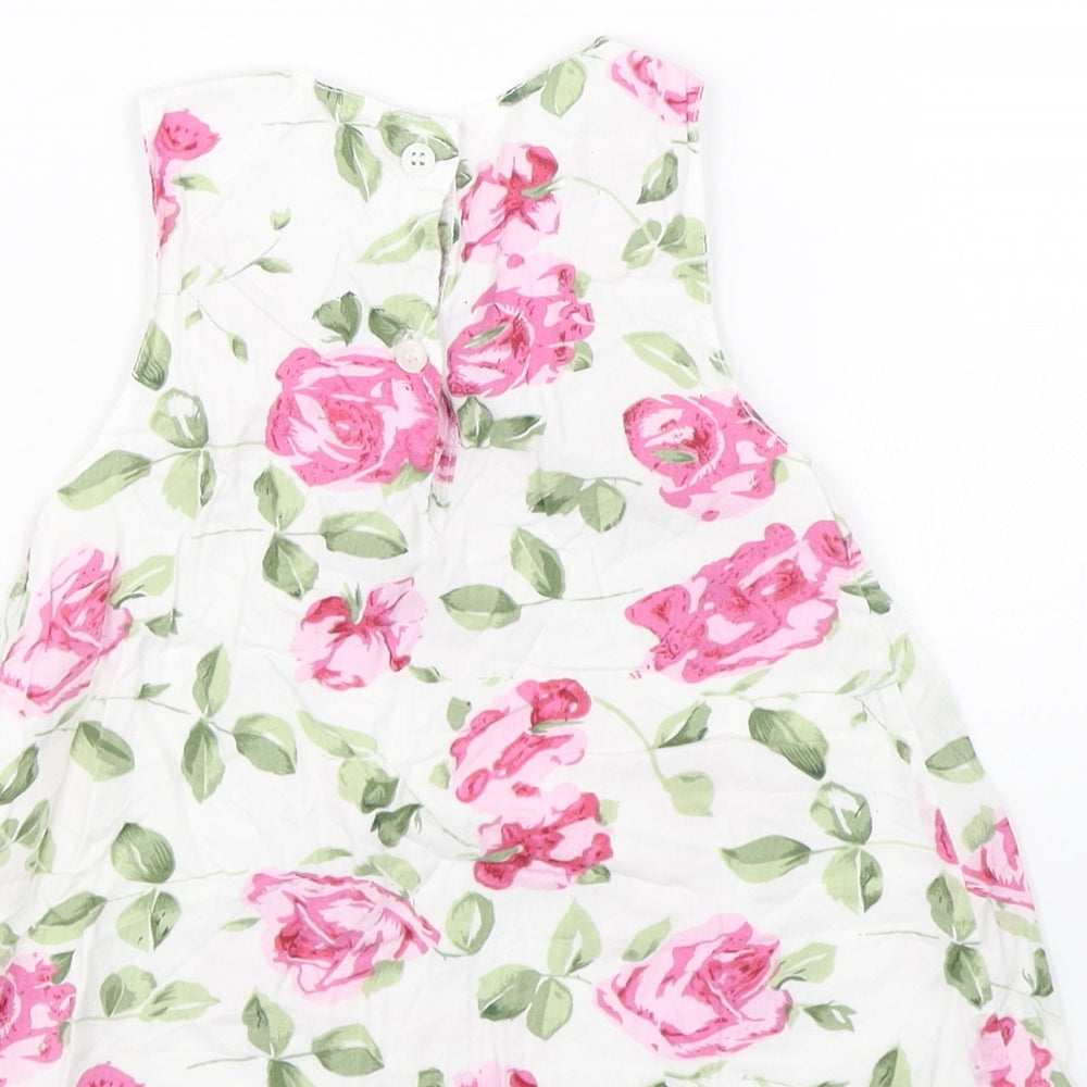 Brand and care label for Early Days girls’ white floral tank dress, size 3-6, months