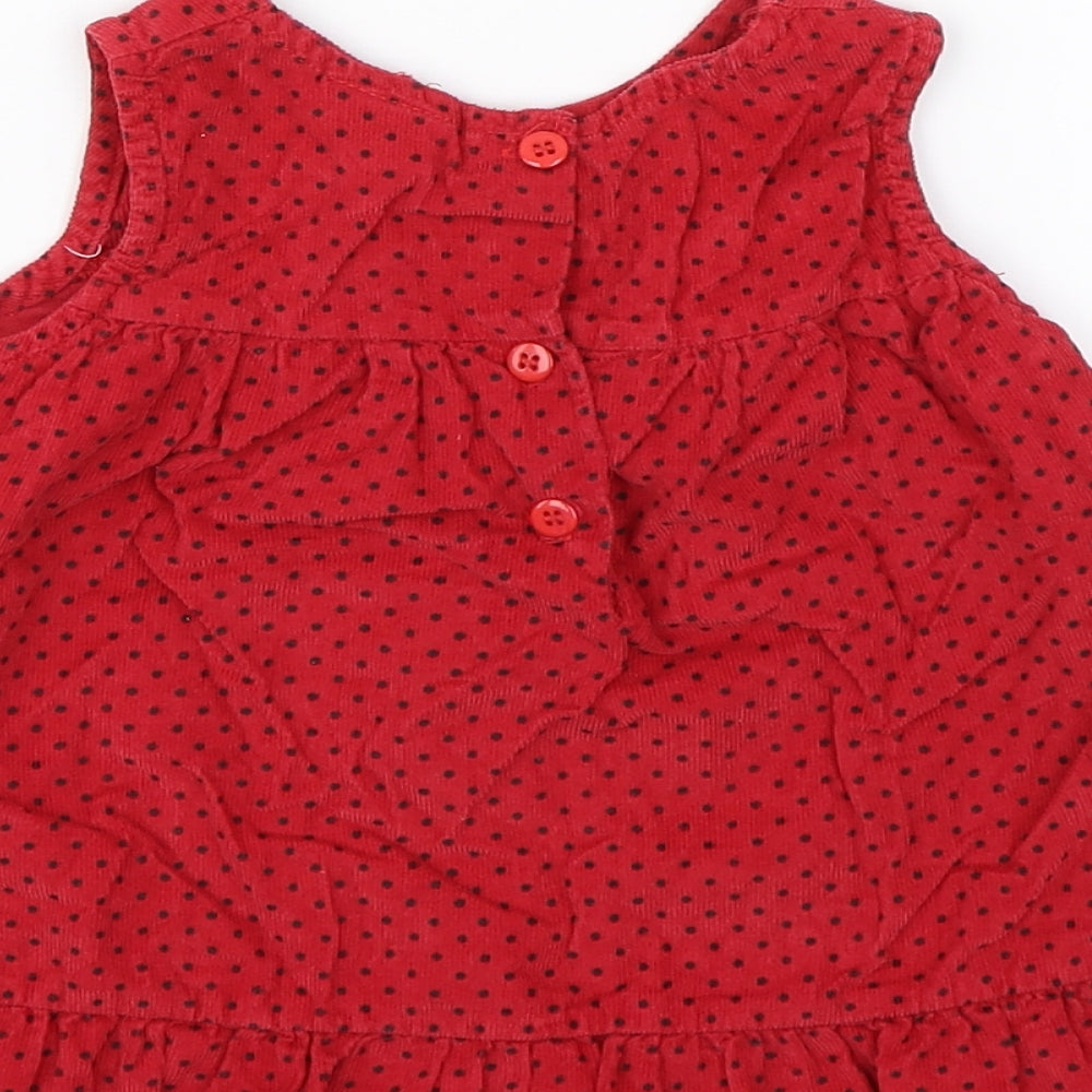 Brand and care label for Cutey Couture girls’ red polka dot corduroy tank dress, size 6-9, months