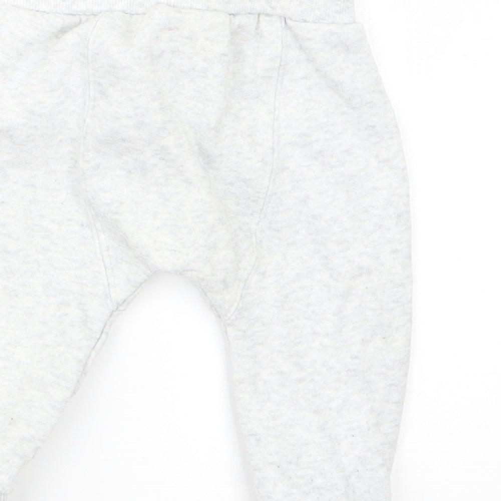 Brand and care label for F&F boys’ grey jogger trousers, size 3-6, months