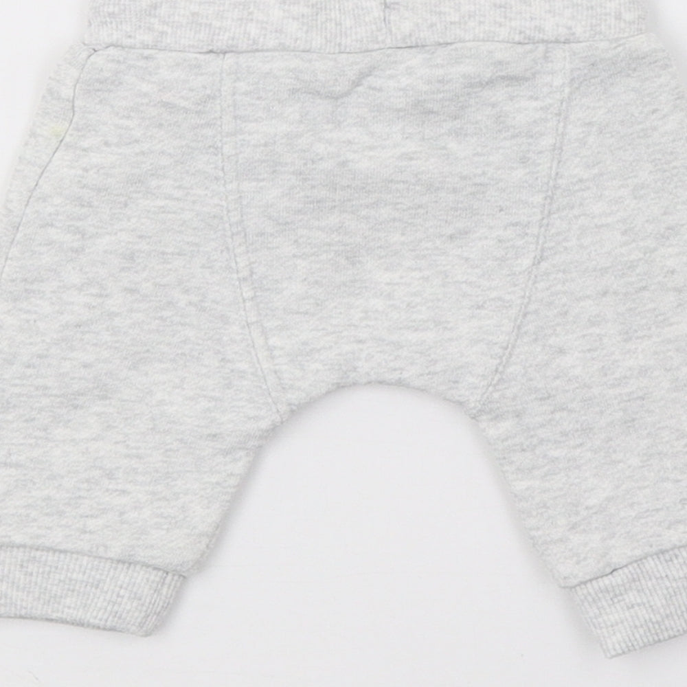 Brand and care label for F&F boys’ grey jersey jogger trousers, size 0-3, months