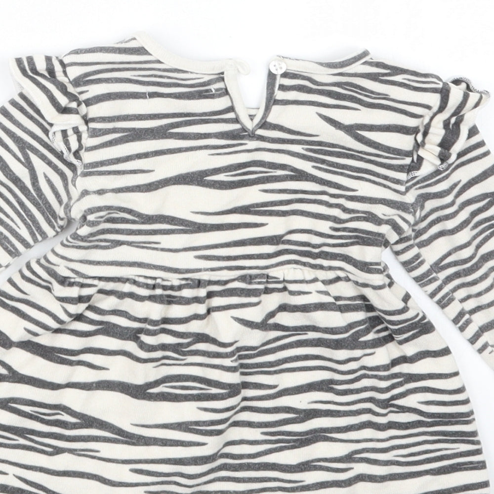 Brand and care label for Primark girls’ black animal print t-shirt dress, size 9-12, months
