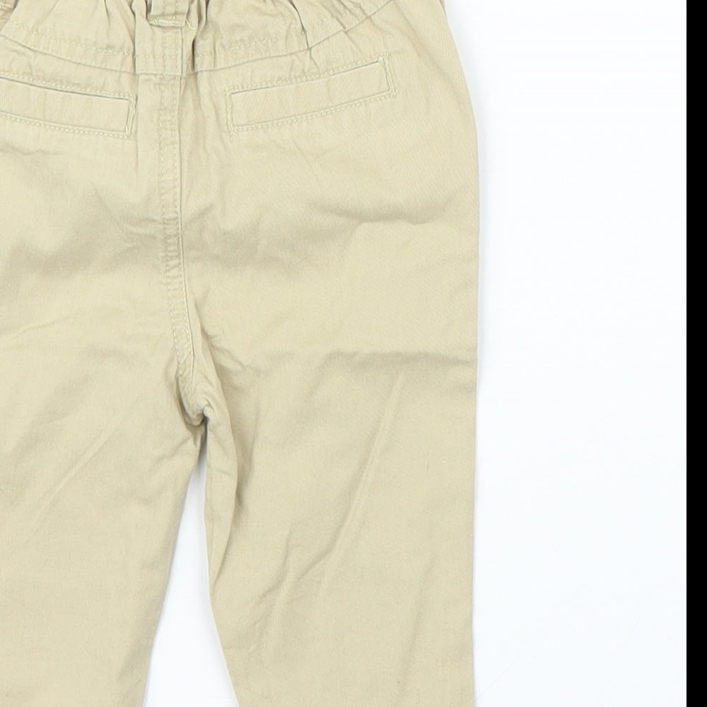 Brand and care label for F&F boys’ beige capri trousers, size 3-6, months