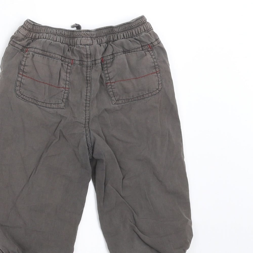 Brand and care label for Cherokee boys’ grey jogger trousers, size 9-12, months