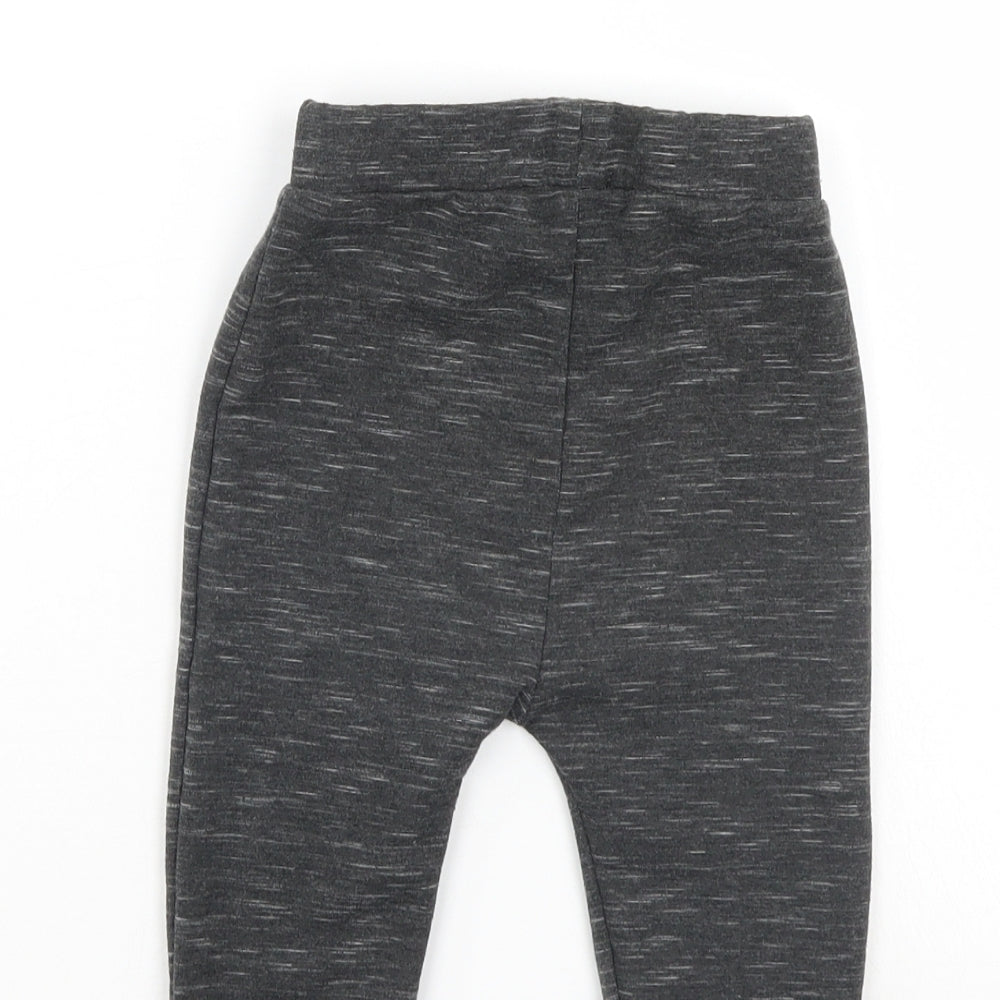 Brand and care label for Disney boys’ black sweatpants, size 6-9, months