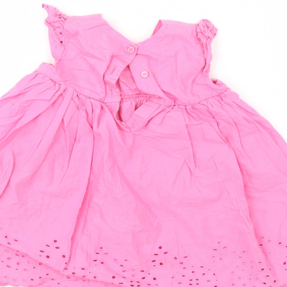Brand and care label for Mothercare girls’ pink floral a-line, size 9-12, months