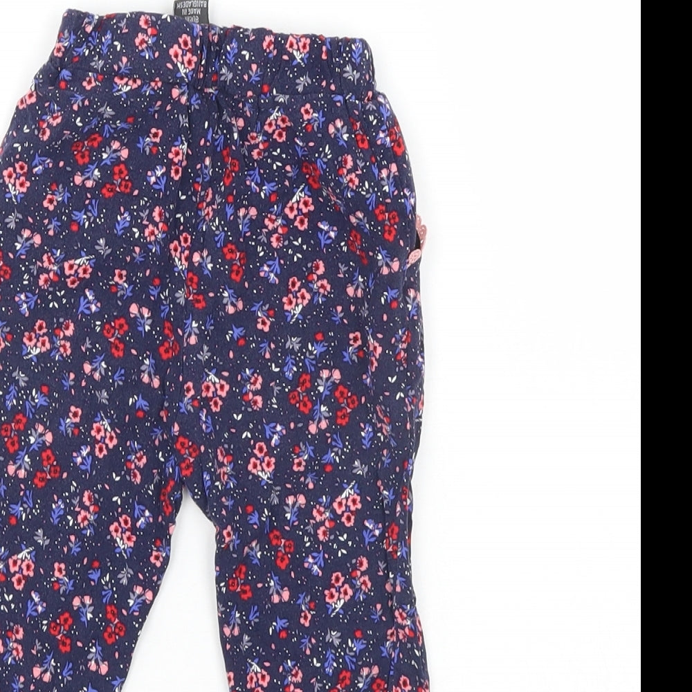 Brand and care label for Primark girls’ blue floral pedal pusher trousers, size 9-12, months