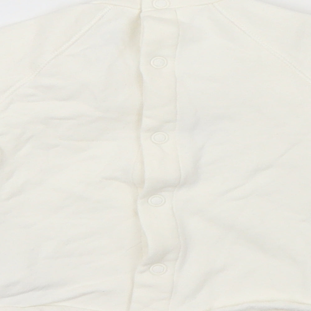 Brand and care label for River Island girls’ white jumper, size 6-9, months - smile