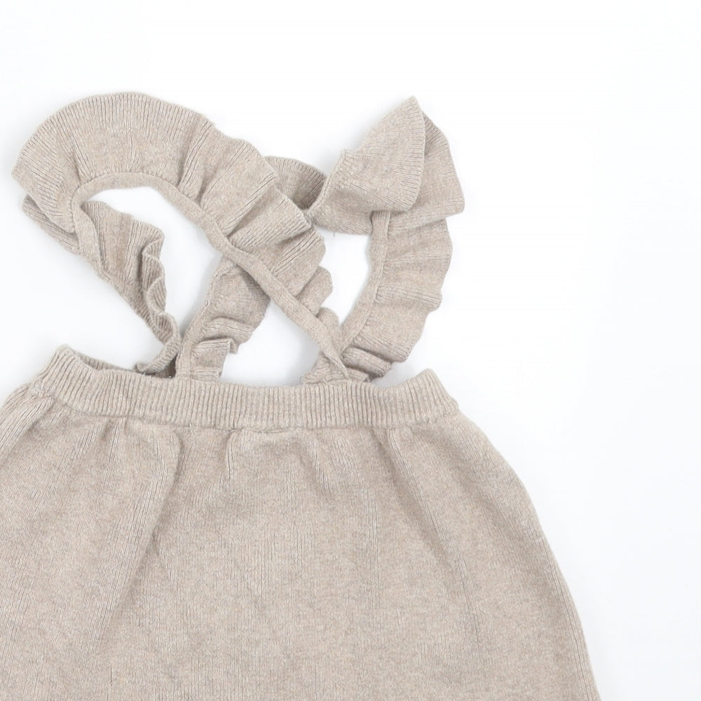 Brand and care label for H&M girls’ beige knit a-line skirt, size 3-6, months - with braces