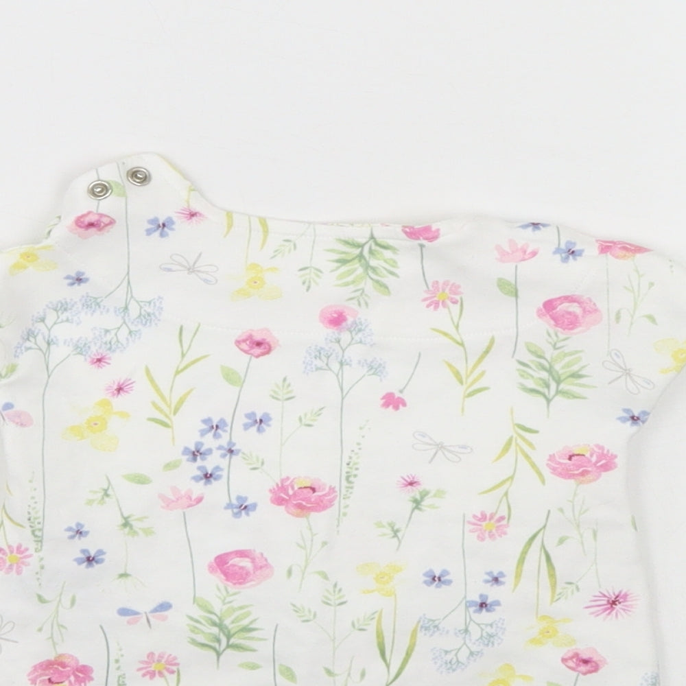 Brand and care label for Mothercare girls’ white floral tunic blouse, size 0-3, months
