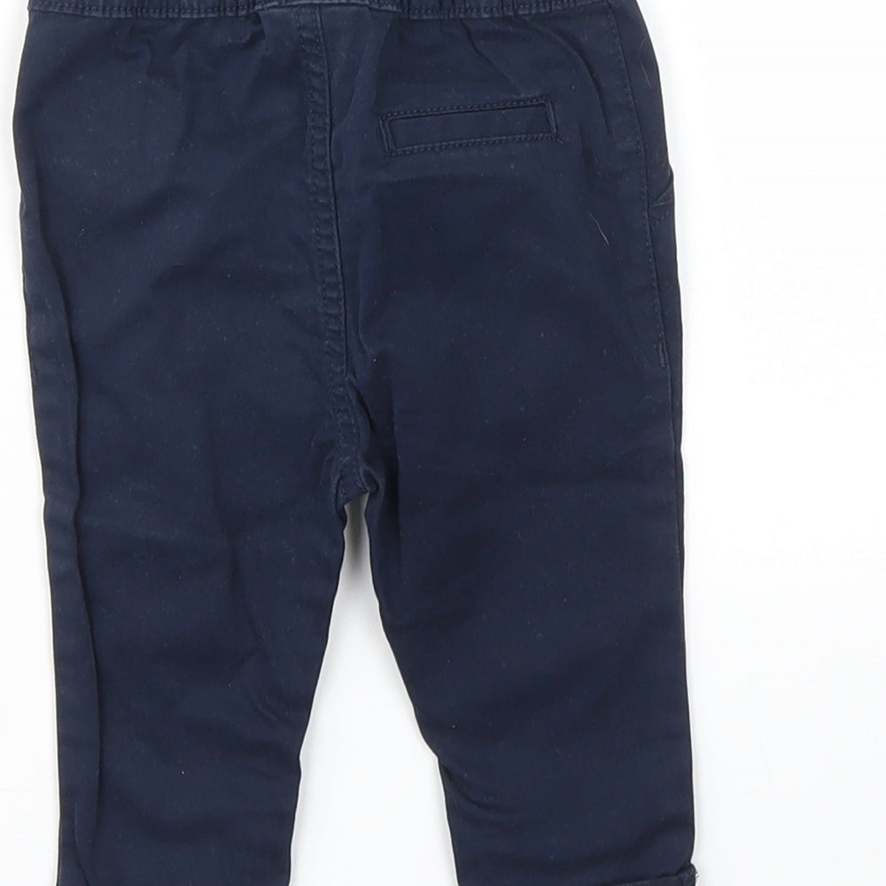 Brand and care label for Next girls’ blue capri trousers, size 3-6, months