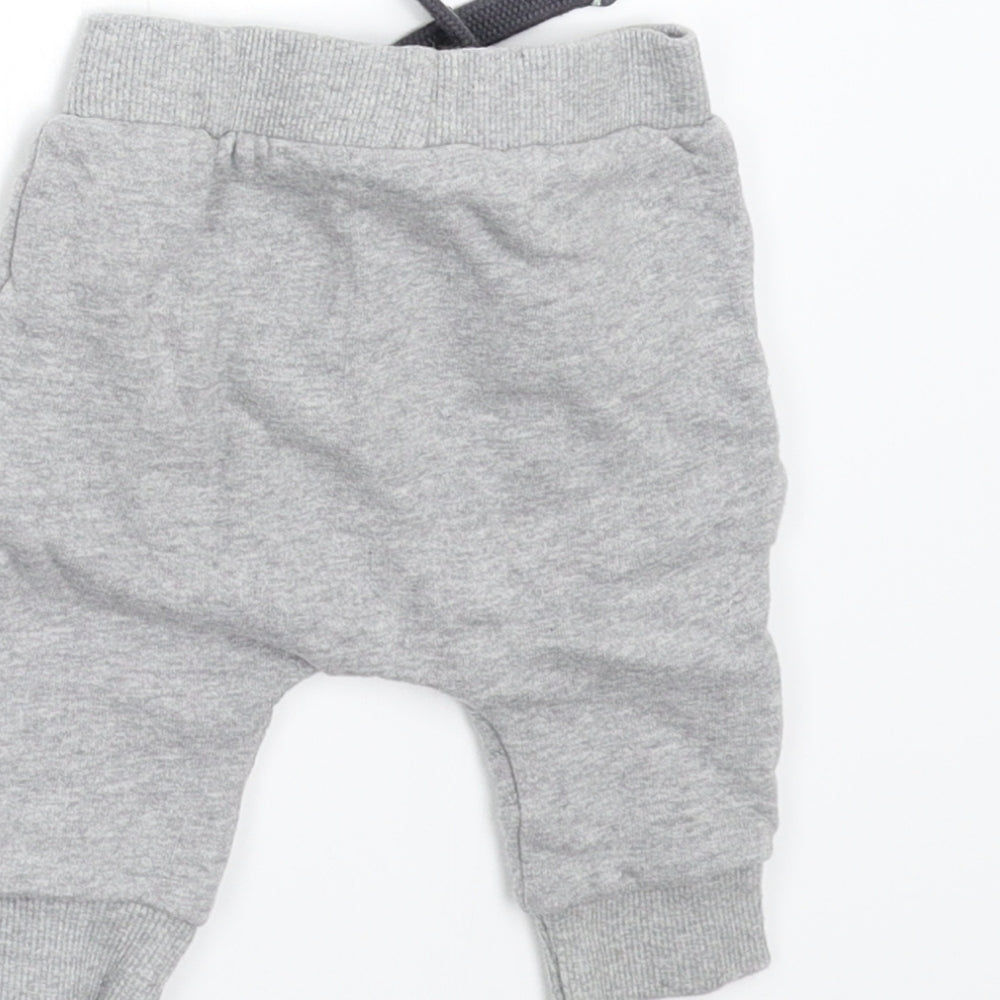 Brand and care label for Mini Club Baby Grey Fleece sweatpants, size 0-3, Months