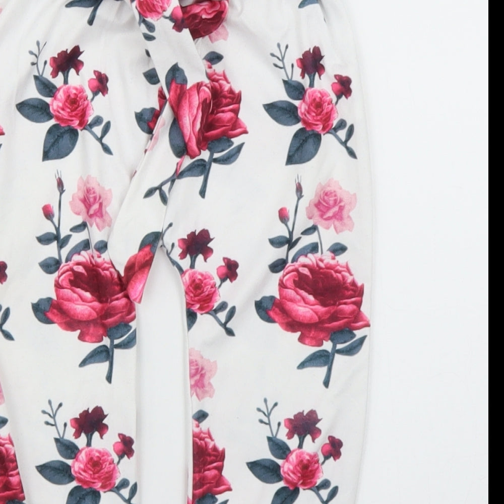 Brand and care label for Preworn girls’ white floral capri leggings, size 12, months