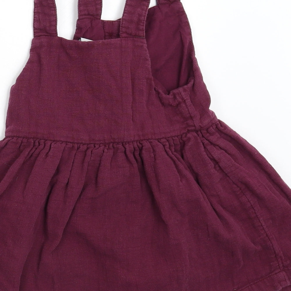 Brand and care label for Tu girls’ purple corduroy fit & flare, size 18, months