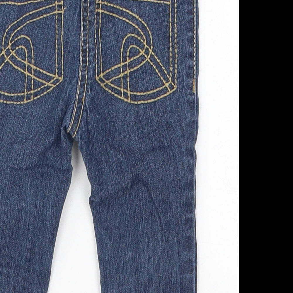 Brand and care label for Next girls’ blue denim capri jeans, size 6-9, months