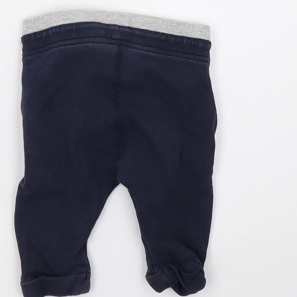 Brand and care label for Marks & Spencer boys’ blue sweatpants, size 0-3, months