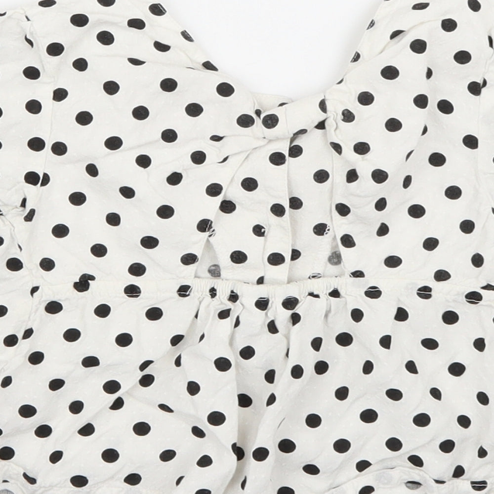 Brand and care label for M&Co girls’ white polka dot basic blouse, size 5-6, years