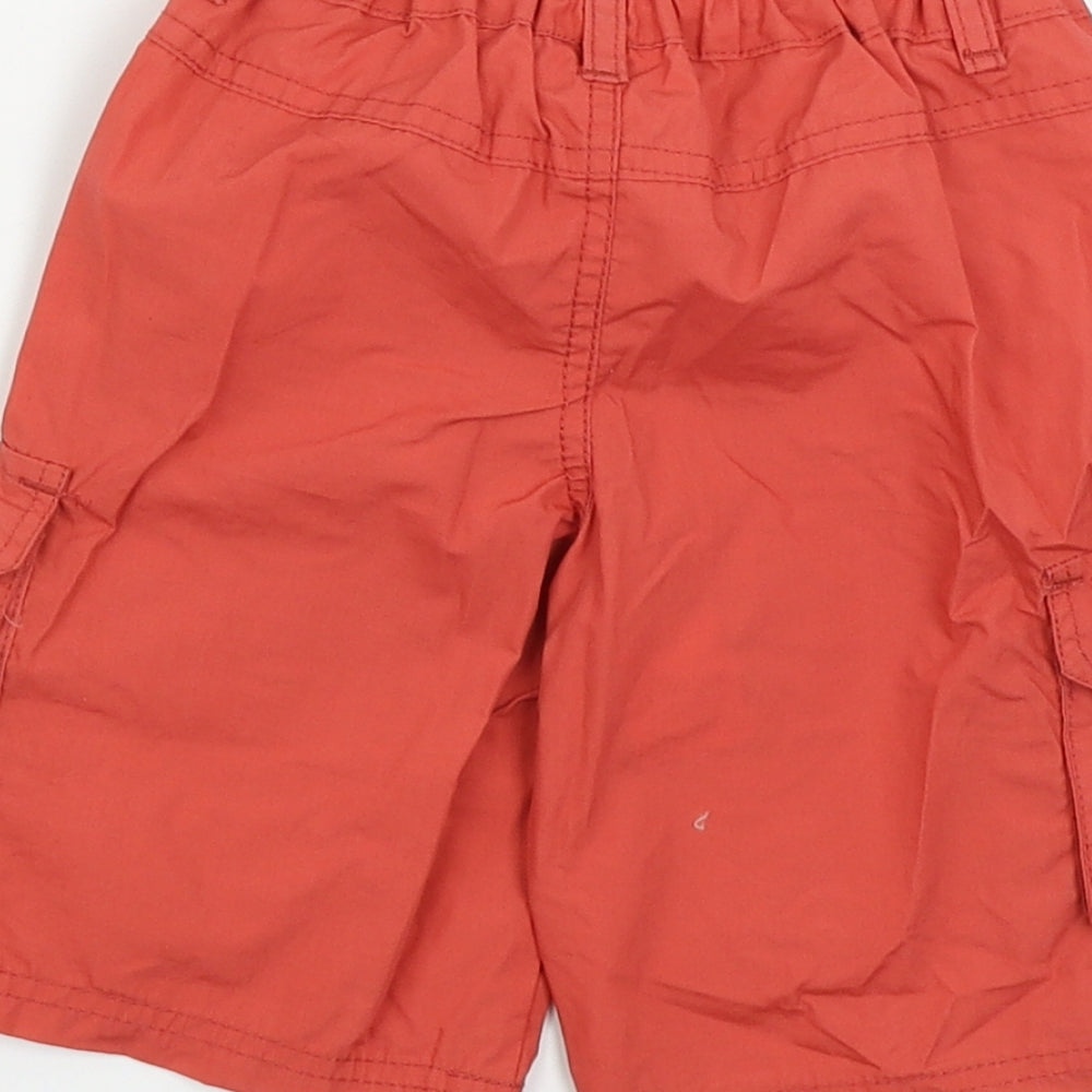 Brand and care label for Cuddlesome boys’ red cropped trousers, size 12-18, months