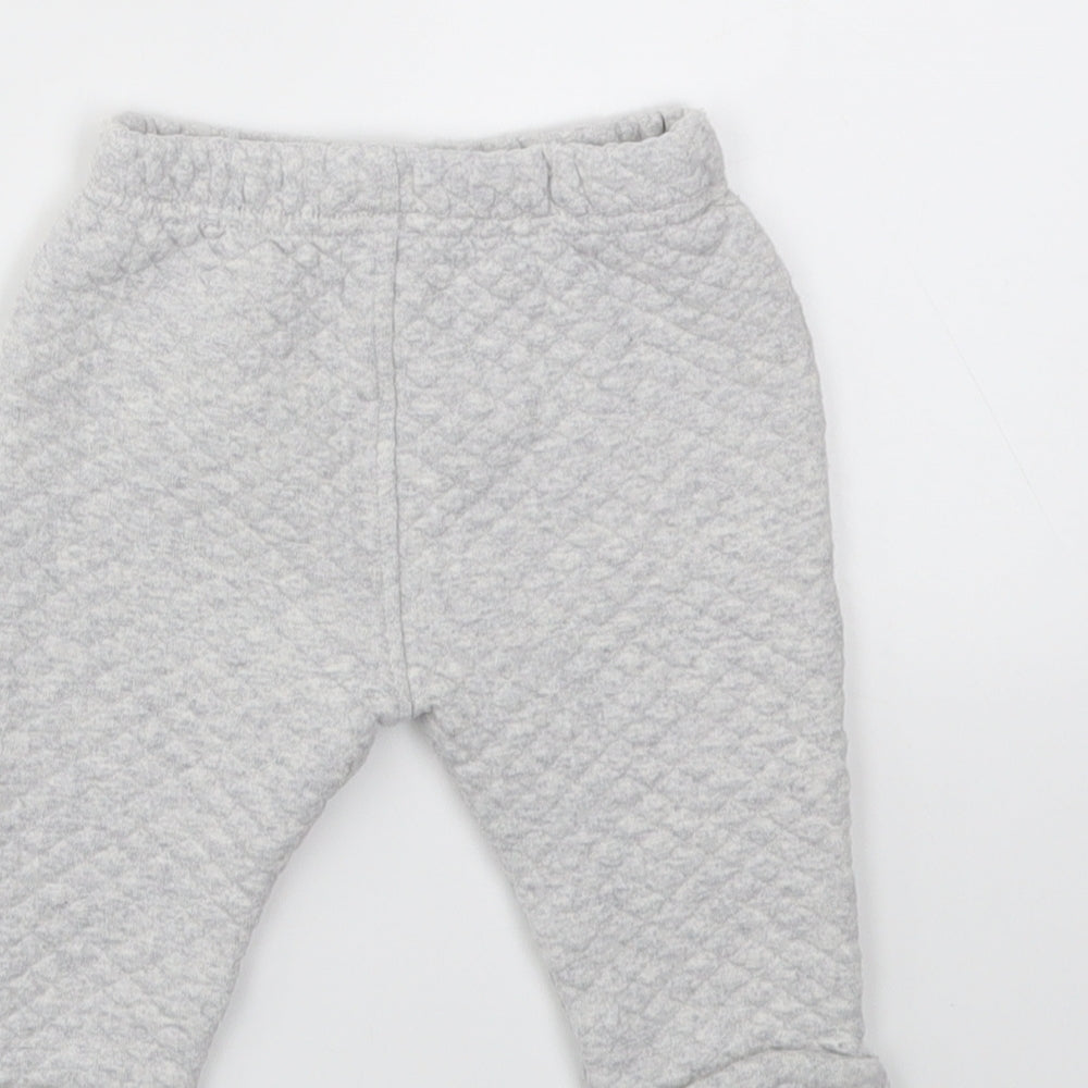 Brand and care label for Marks & Spencer boys’ grey capri trousers, size 6-9, months