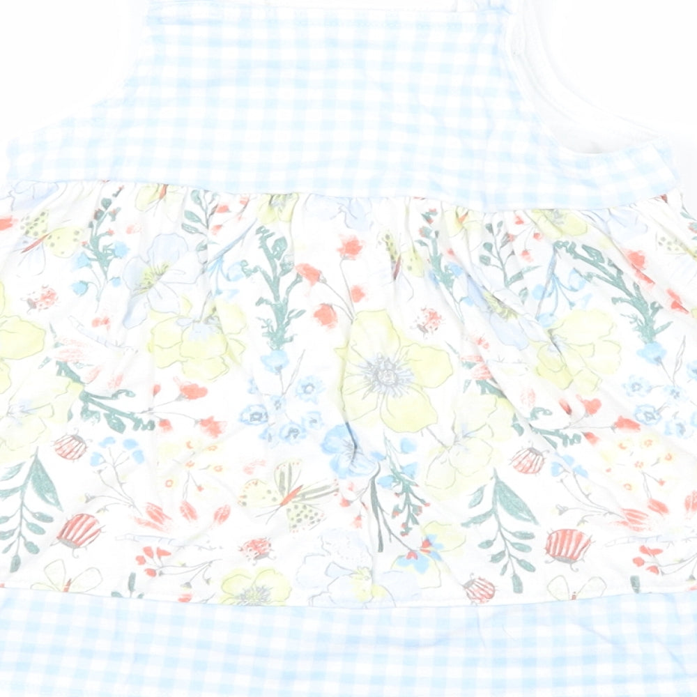 Brand and care label for Nutmeg girls’ floral pinafore/dungaree dress, size 3-6, months