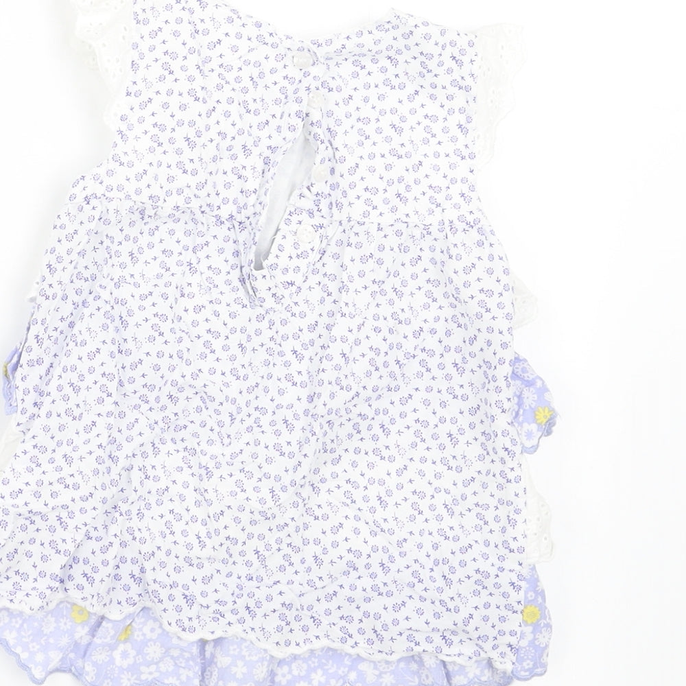 Brand and care label for Mothercare girls’ blue floral a-line, size 12-18, months