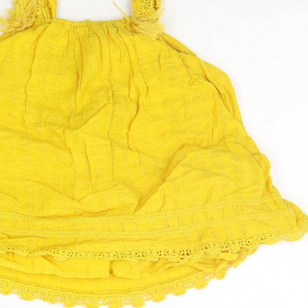 Brand and care label for Matalan girls’ yellow a-line, size 9-12, months