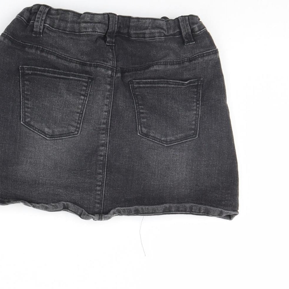 Brand and care label for Miss evie girls’ black denim mini skirt, size 8, years