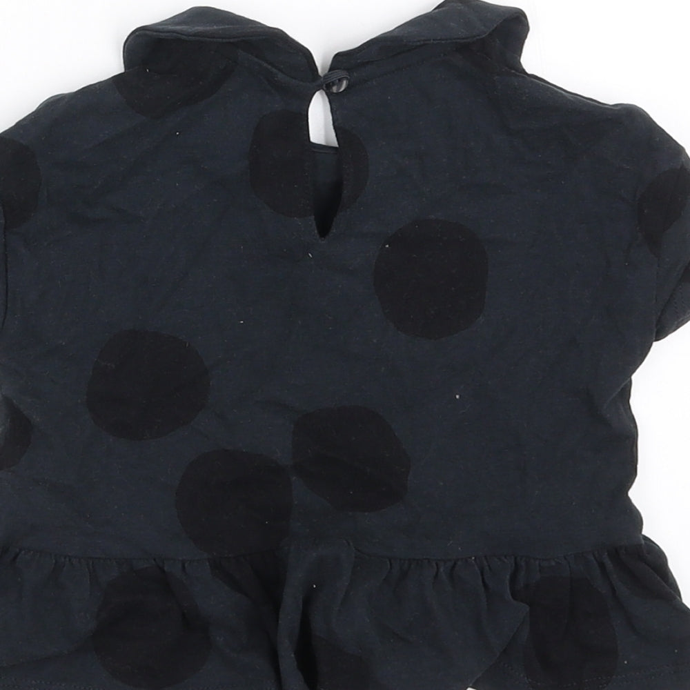 Brand and care label for Next girls’ black polka dot basic t-shirt, size 9-12, months
