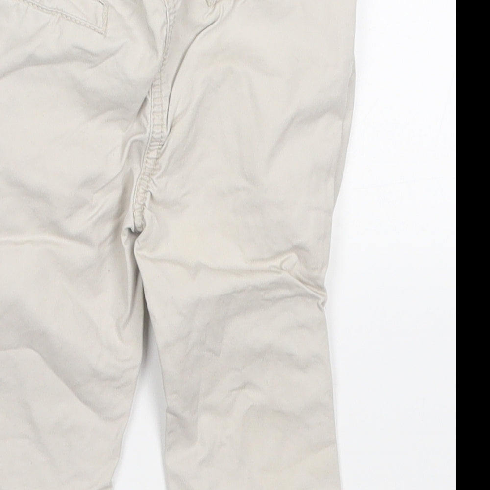 Brand and care label for F&F boys’ grey cargo trousers, size 9-12, months