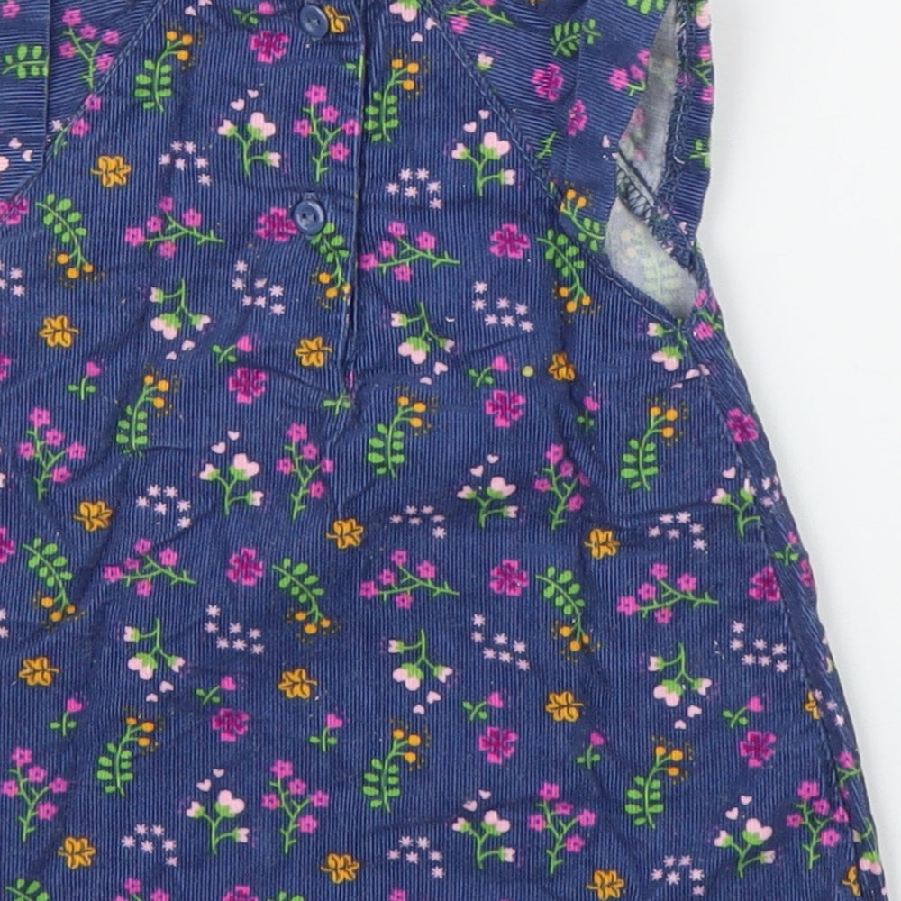 Brand and care label for Baby Club girls’ blue floral corduroy a-line, size 0-3, months