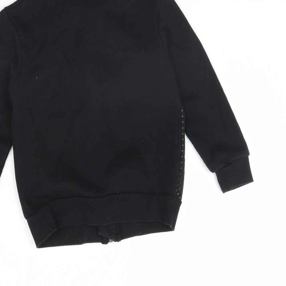 Brand and care label for Minoti girls’ black jacket, size 4, years