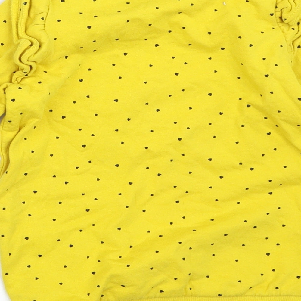 Brand and care label for So Cute girls’ yellow jumper, size 18-24, months